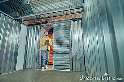 Man with tablet entering garage box Stock Photo