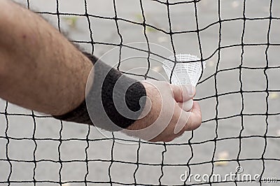Man taking a badminton shuttlecock Stock Photo