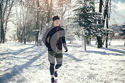 Man Taking Break From Running in Extreme Snow Conditions Stock Photo