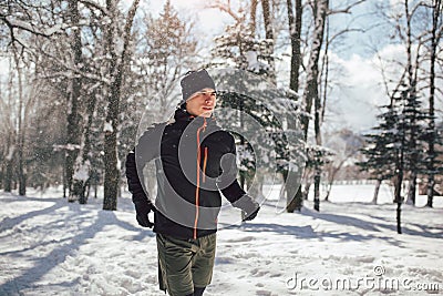 Man Taking Break From Running in Extreme Snow Conditions Stock Photo