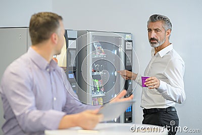 Man taking coffee from vending machine Stock Photo