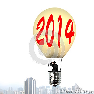 Man taking glowing lamp balloon floating over city building Stock Photo