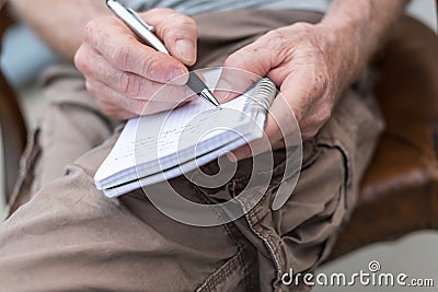 Man taking notes on a pocket book Stock Photo