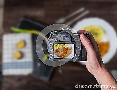 Man taking photo of chicken steak or schnitzel with mashed potatoes Stock Photo