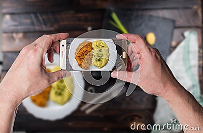 Man taking photo of Chicken steak or schnitzel with mashed potatoes Stock Photo