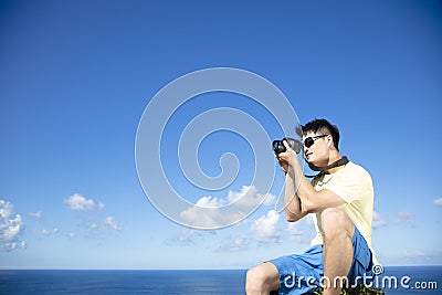 Man taking photo of ocean view Stock Photo