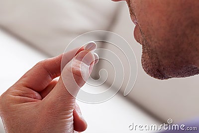 Man taking a pill Stock Photo