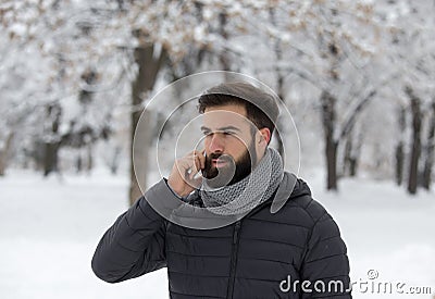 Man talking on phone on snow Stock Photo