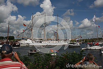 Man taking a picture of a three master during Sail Amsterdam Editorial Stock Photo