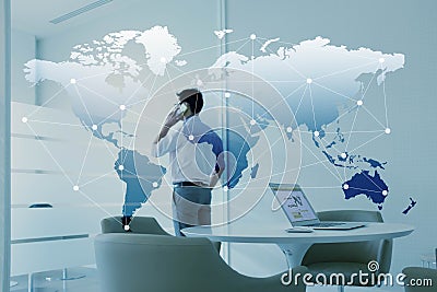 Man talking via mobile phone and laptop with globalization Stock Photo