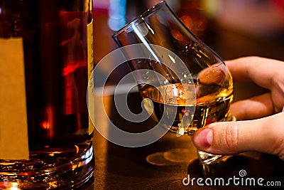Man tasting single malt whiskey from glencairn whiskey glass Stock Photo