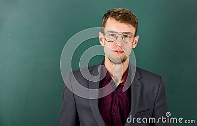 Man teacher wear eyeglasses for vision green chalkboard background, intelligent guy concept Stock Photo