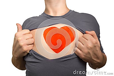 Man tearing apart grey t-shirt. Red heart painted on his chest i Stock Photo