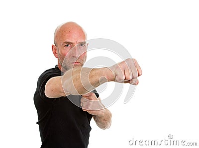 Man in teeshirt throwing a punch Stock Photo