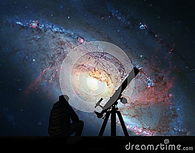 Man with telescope looking at the stars. Spiral Galaxy M106 Stock Photo