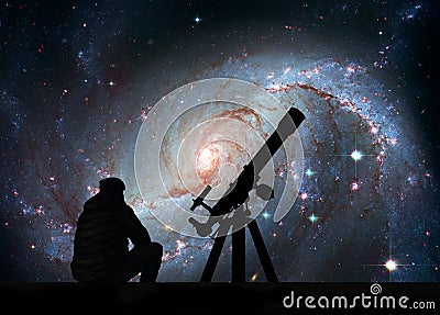 Man with telescope looking at the stars. Stellar Nursery NGC 1672. Spiral galaxy in the constellation Dorado.Elements of this Stock Photo