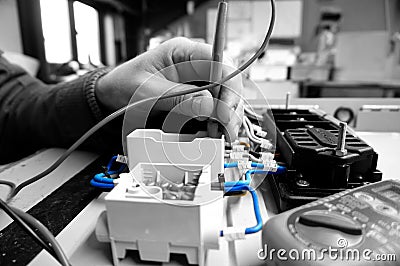 Man testing electric wiring with a Multimeter abstract Stock Photo