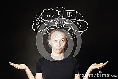 Man thinking with question mark and hand drawing sketch bubble on blackboard background. Choice, problem and solution concept Stock Photo
