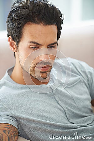 Man, thinking and sofa for problem in home or lonely grief mourning, broken heart or stress. Male person, unhappy Stock Photo