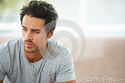 Man, thinking and sofa for sad in home or lonely grief mourning, broken heart or stress. Male person, unhappy thoughts Stock Photo