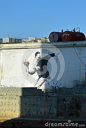 Man throwing flowers by Banksy Editorial Stock Photo