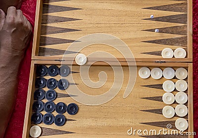 Man throws dice while playing bacgammon Stock Photo