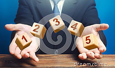 Man throws 5 numbered blocks with the numbers one two three four five from his hands. Five easy steps. Organization Stock Photo