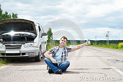 Man with tools showing thumbs up near his broken car Stock Photo