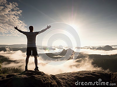 Man at the top of a mountain looking the misty landscape. Feel free Stock Photo