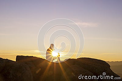 Man on top watching the sunset - 3 Stock Photo
