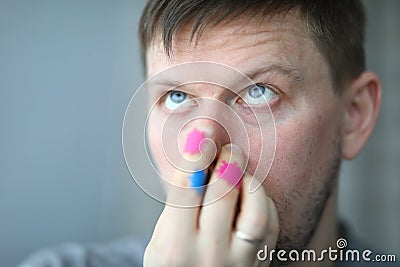Man touches nose, on hands microbe of coronavirus Stock Photo