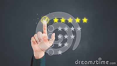 Man touching the virtual screen on five star icon to give satisfaction in service. Rating very impressed. Stock Photo