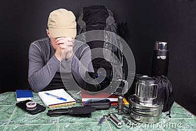 Man a tourist makes a plan for a hike in nature Stock Photo