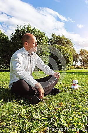 Man toy bear businessman loneliness sad handsome thinks about life Stock Photo
