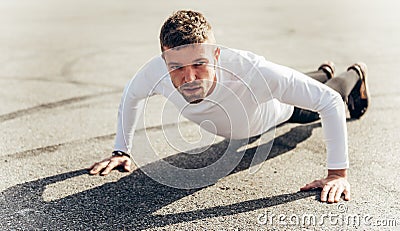 Man training push up outdoors. Handsome man doing push-ups outdoors Stock Photo