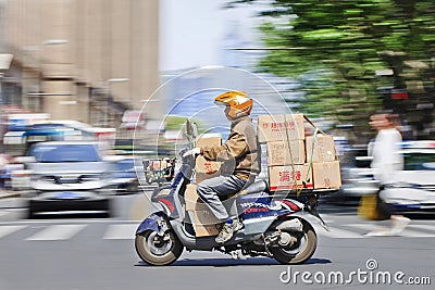 Man transports boxes ona scooter, Shanghai, China Editorial Stock Photo