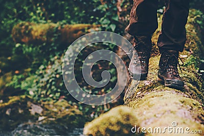 Man Traveler crossing over river on woods outdoor Stock Photo