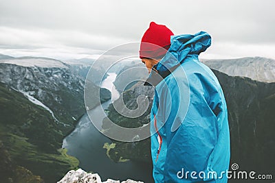 Man traveler on mountain top standing alone Stock Photo