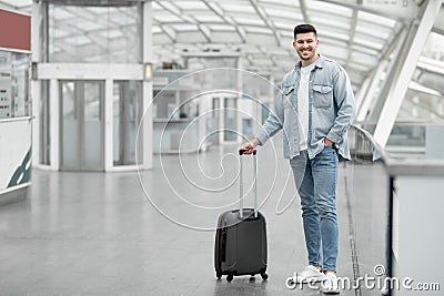 Man Traveler Posing With Suitcase Luggage Standing At Airport Indoor Stock Photo