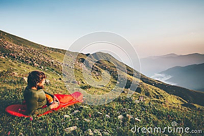 Man Traveler relaxing in sleeping bag camping Stock Photo