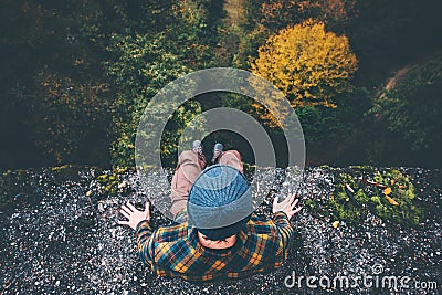 Man Traveler sitting on cliff bridge edge Stock Photo