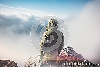 Man Traveler standing on mountain summit Stock Photo