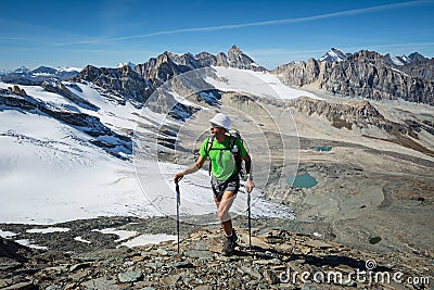 Man trekking in the Alps in a beautiful sunny day. Grand Paradiso National Park. Italy Stock Photo