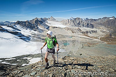 Man trekking in the Alps in a beautiful sunny day. Grand Paradiso National Park. Italy Stock Photo