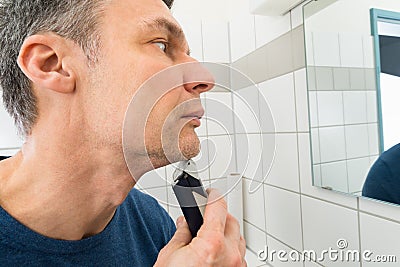 Man trimming beard Stock Photo