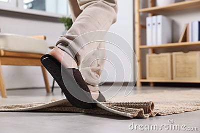 Man tripping over rug at home, closeup. Space for text Stock Photo