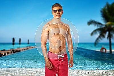 Man at tropical swimming pool Stock Photo