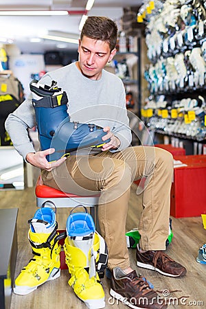 Man is trying on boots which he choose Stock Photo