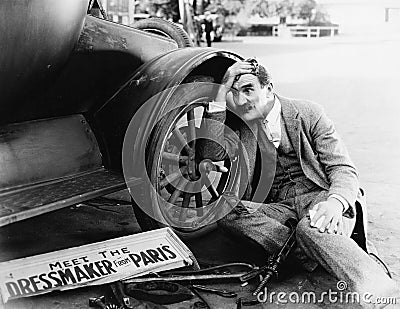 Man trying to fix broken car Stock Photo