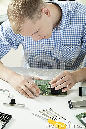 Man trying to repair video card Stock Photo